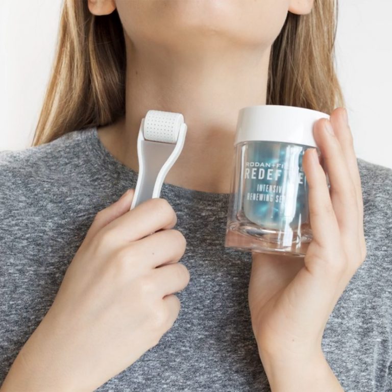 Model holding Rodan and Fields AMP MD System with Intensive Renewing Serum