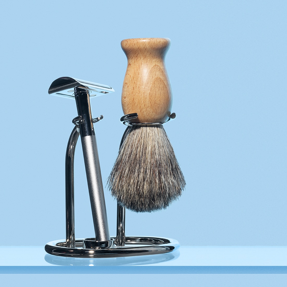Shaving kit showing double-edged safety razor and badger hair brush