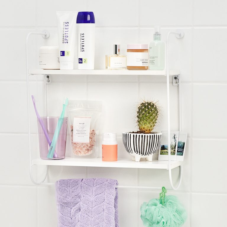 Spotless acne regimen shown on shower shelf with misc shower items
