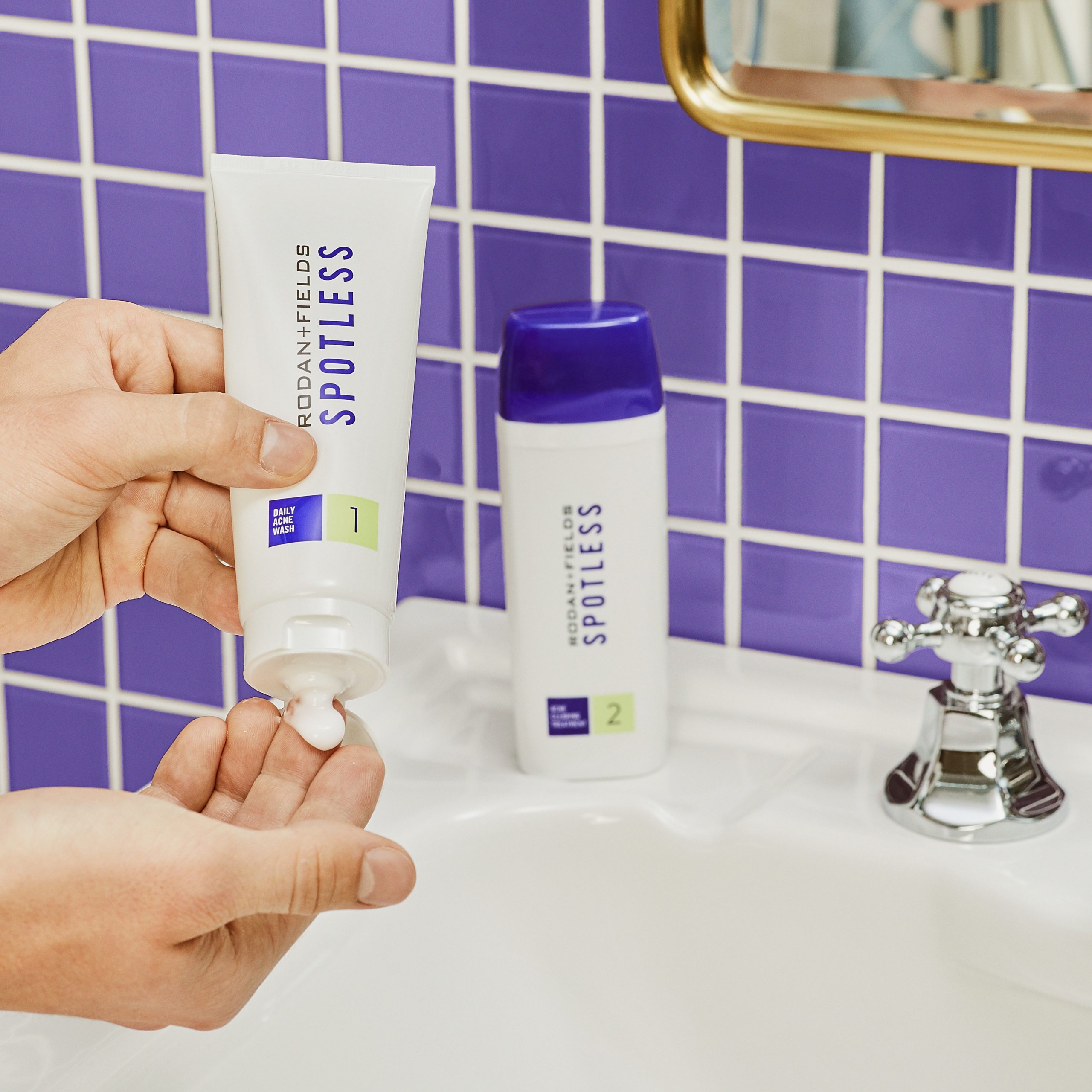 Spotless Acne Regimen applied to the hand on a bathroom counter