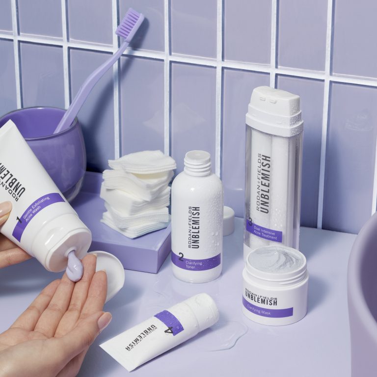 Unblemish Regimen applied to the hand on a bathroom counter