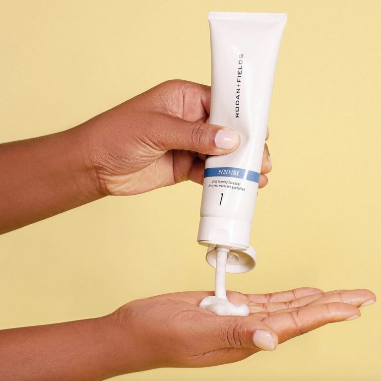 Woman dispensing Rodan + Fields Redefine Foaming Cleanser into her palm