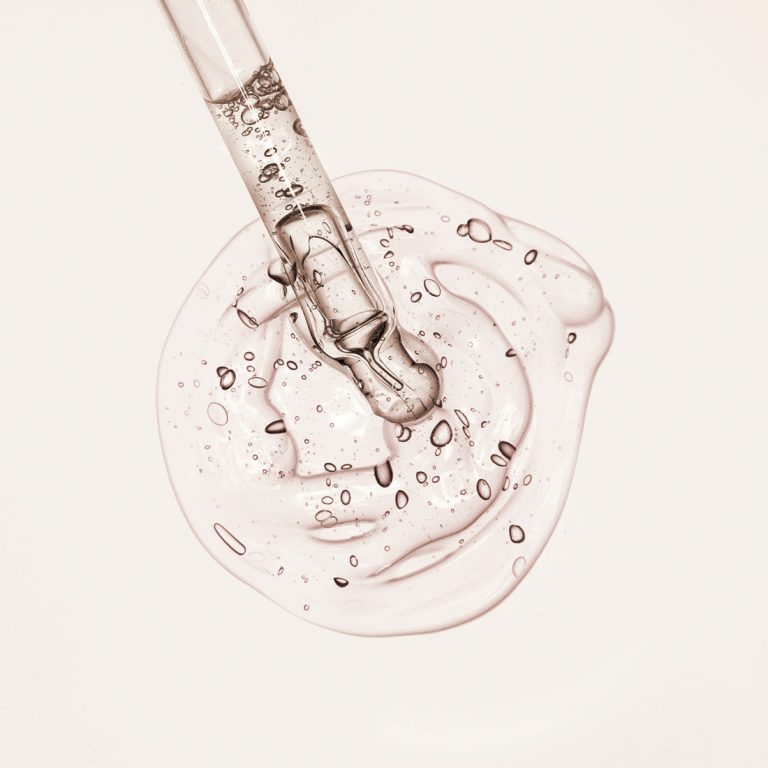 Close up of glass applicator tip showing hydrating serum texture