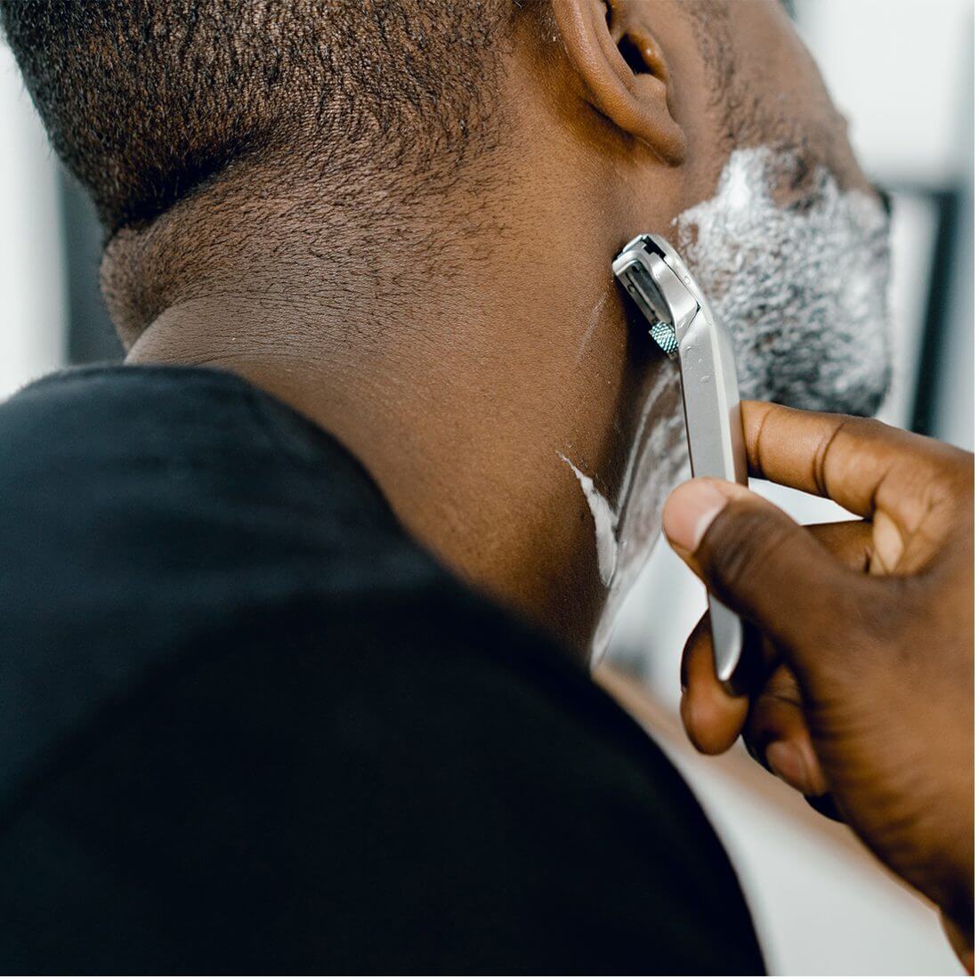Man shaving face with foaming cleanser