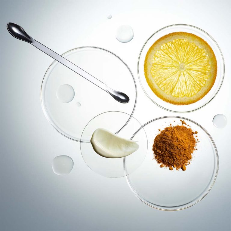 Glass petri dishes containing raw skincare ingredients