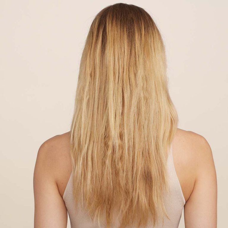 Woman with long blond hair pictured from behind