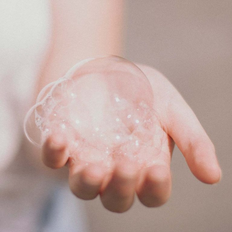 A hand holding lathered shampoo