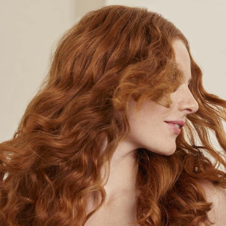 Model showing her long wavy red hair