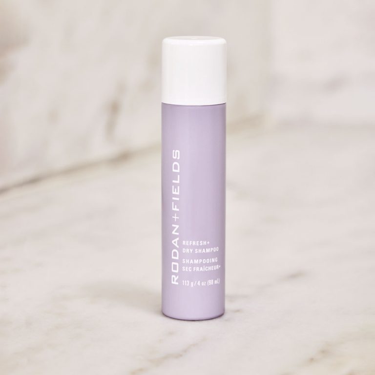 Bottle of Refresh+ Dry Shampoo on a marble counter