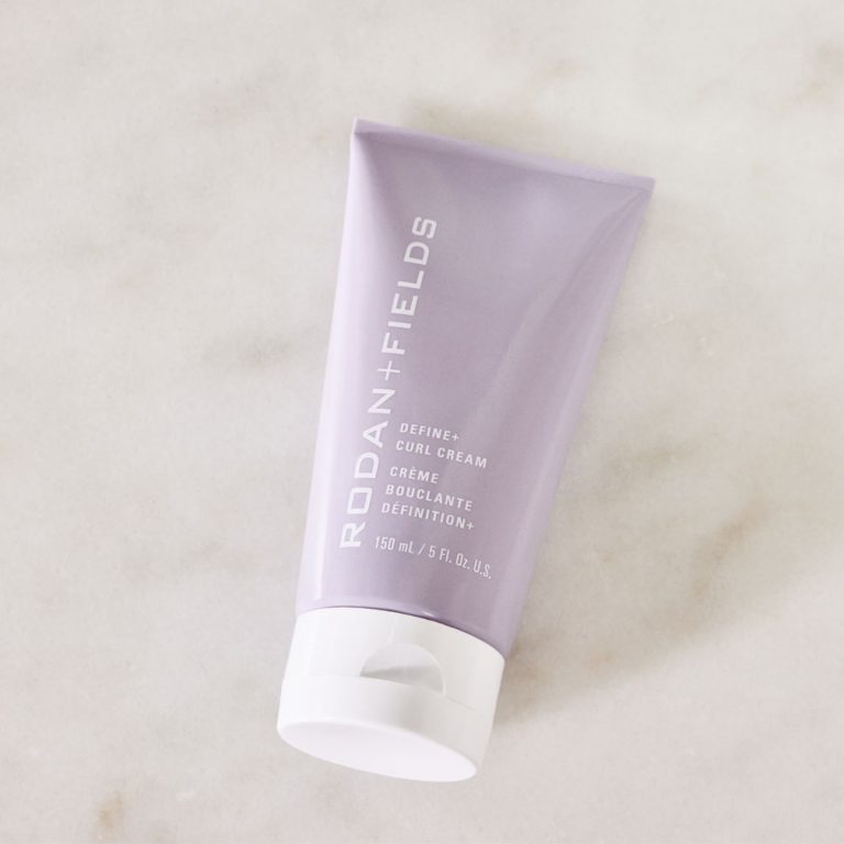 A tube of R+F Define+ Curl Cream on a marble countertop