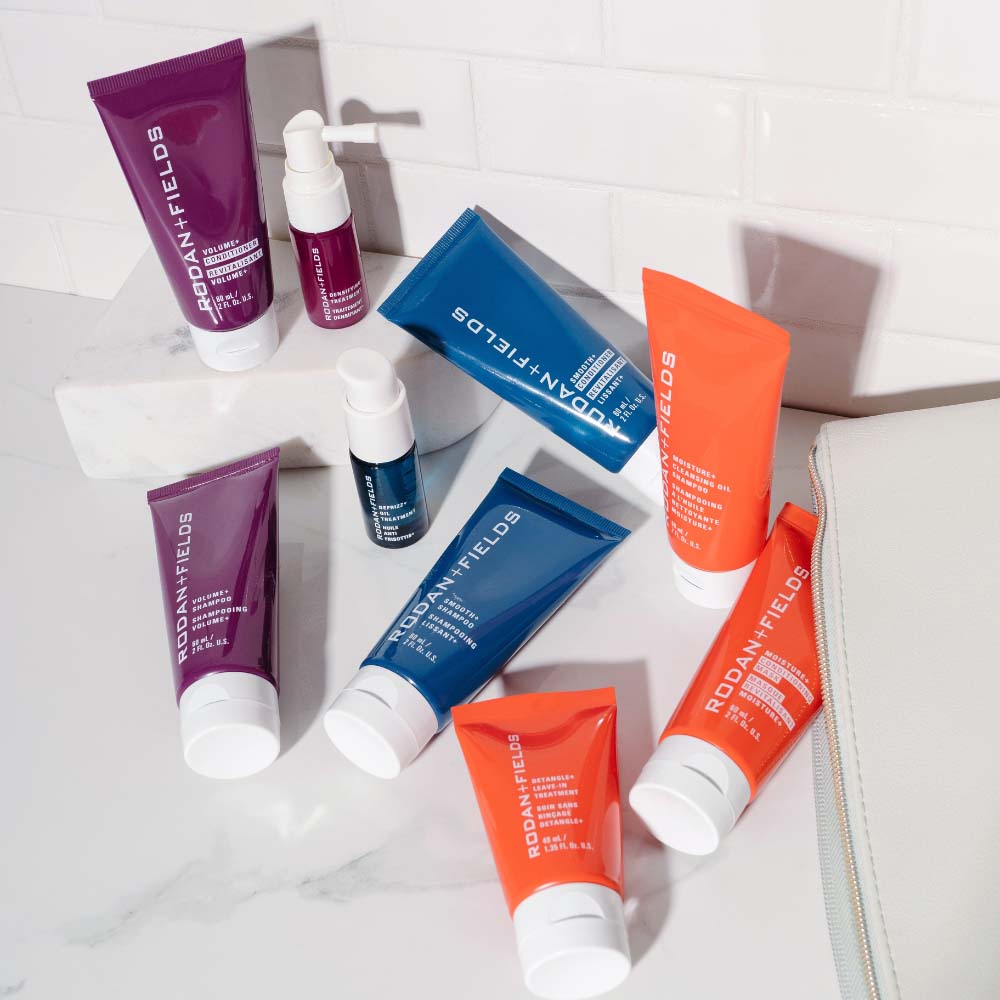 Rodan + Fields haircare travel regimens pictured on a bathroom counter