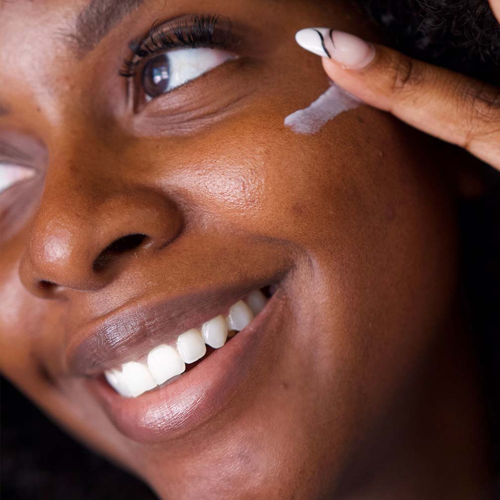 Young woman applying R+F Multi-Acid Enzyme Peel