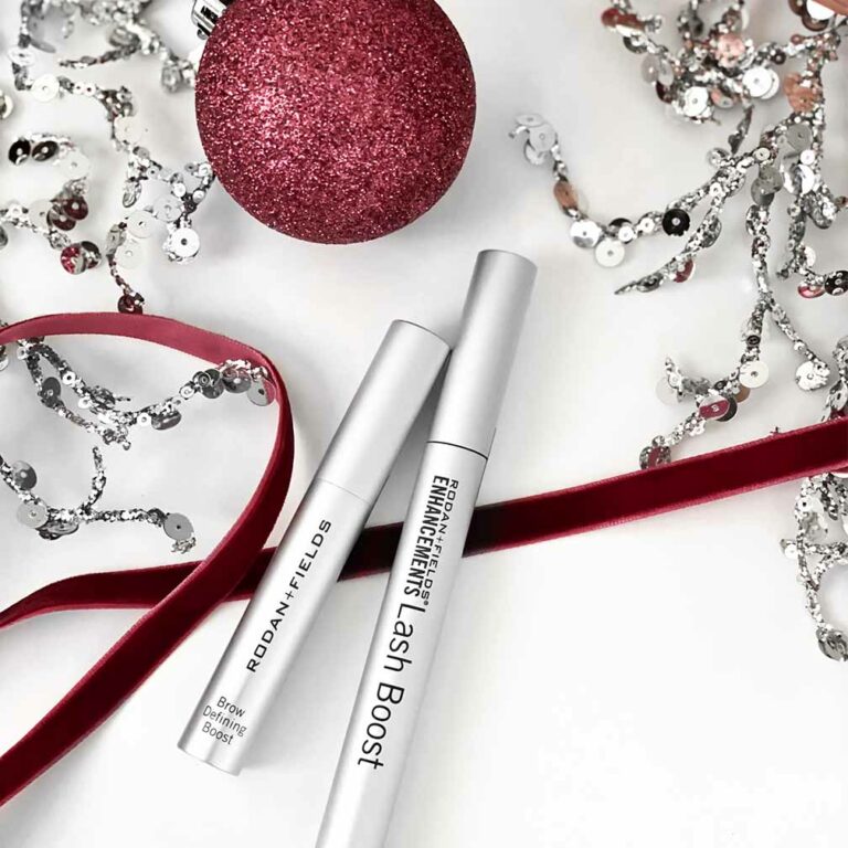 Rodan + Fields Lash Boost and Brow Defining Boost pictured with holiday ornaments and décor.