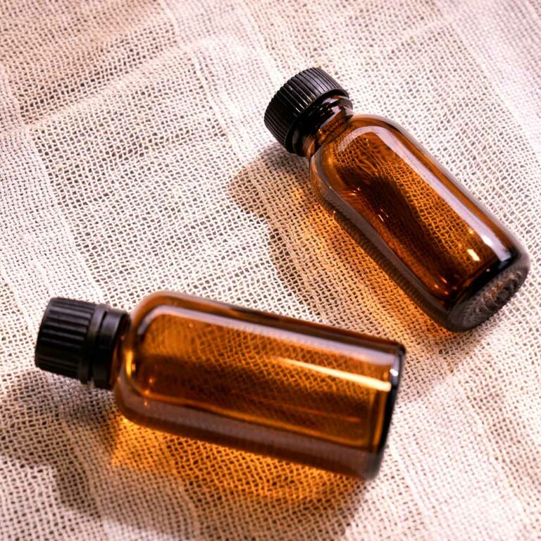 Two dark glass vials on a linen cloth. Photo by Denise Chan.