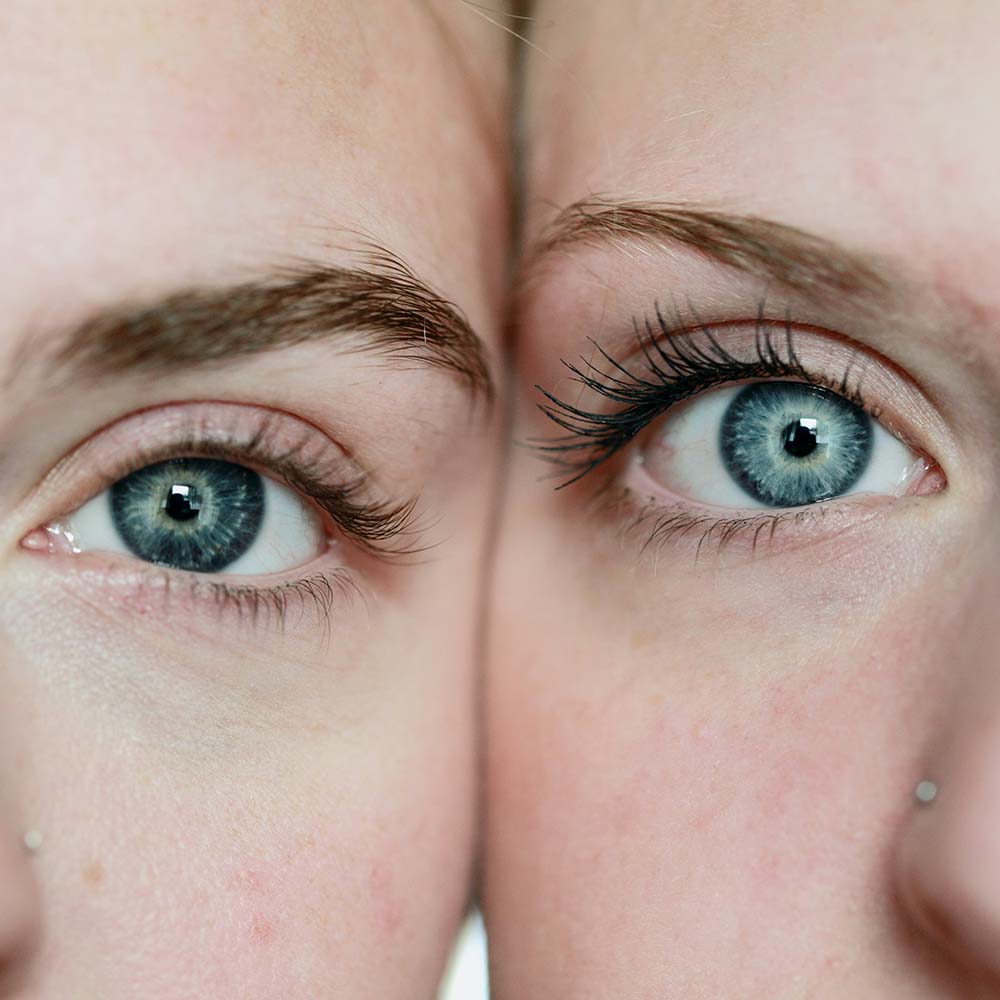 Closeup of two young women's eyes with their heads together. Photo by Alexander Grey