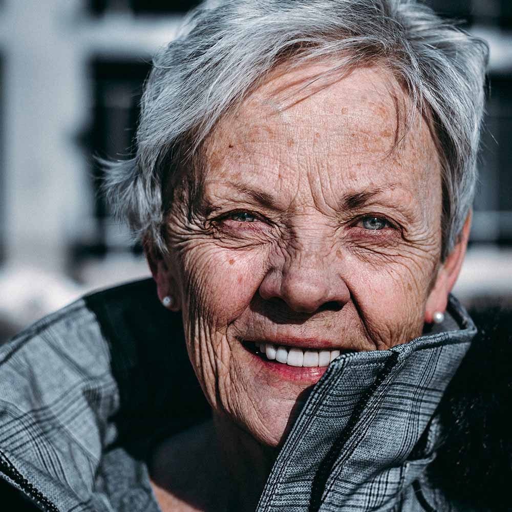 Older woman in a pea coat. Photo by Ravi Patel.