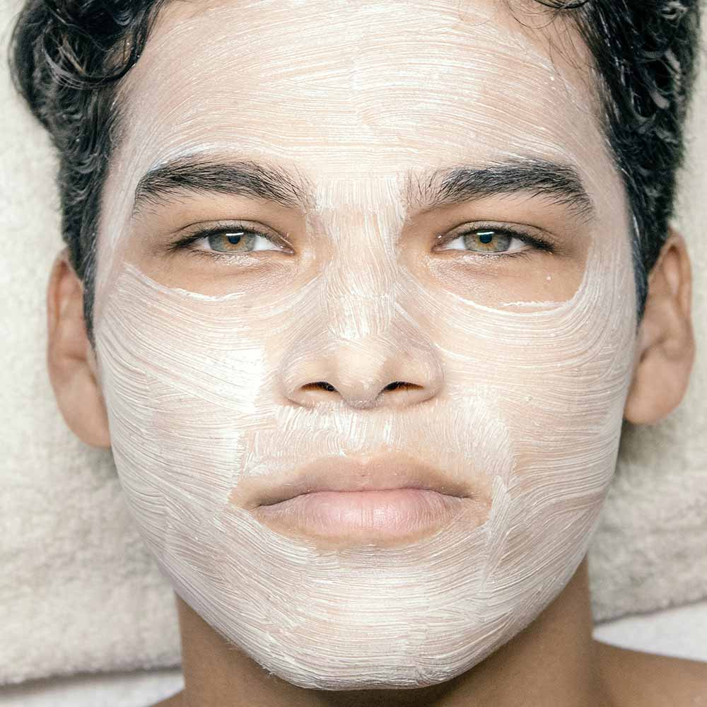 Young man with face mask skin treatment. Photo by Victor Meza