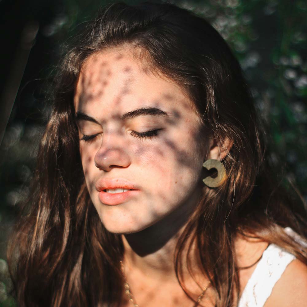 Young woman with eyes closed. Photo by Matteo Minoglio